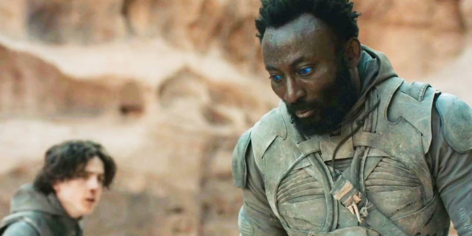 jamis-standing-sullenly-with-paul-bent-over-in-the-background-in-dune-1