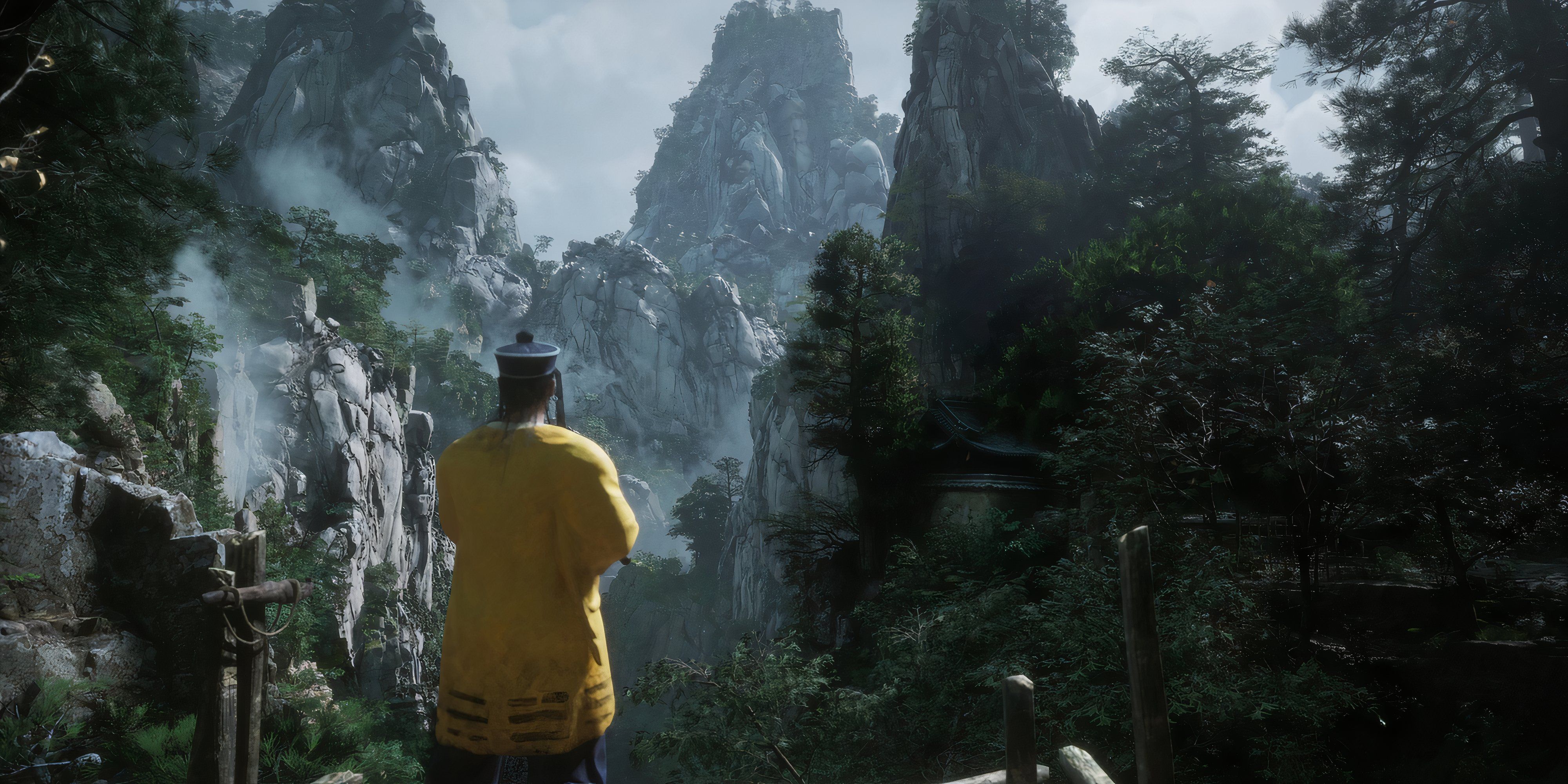 7 Linear Games That Feel Like an Open World Man stands in forest looking towards mountains