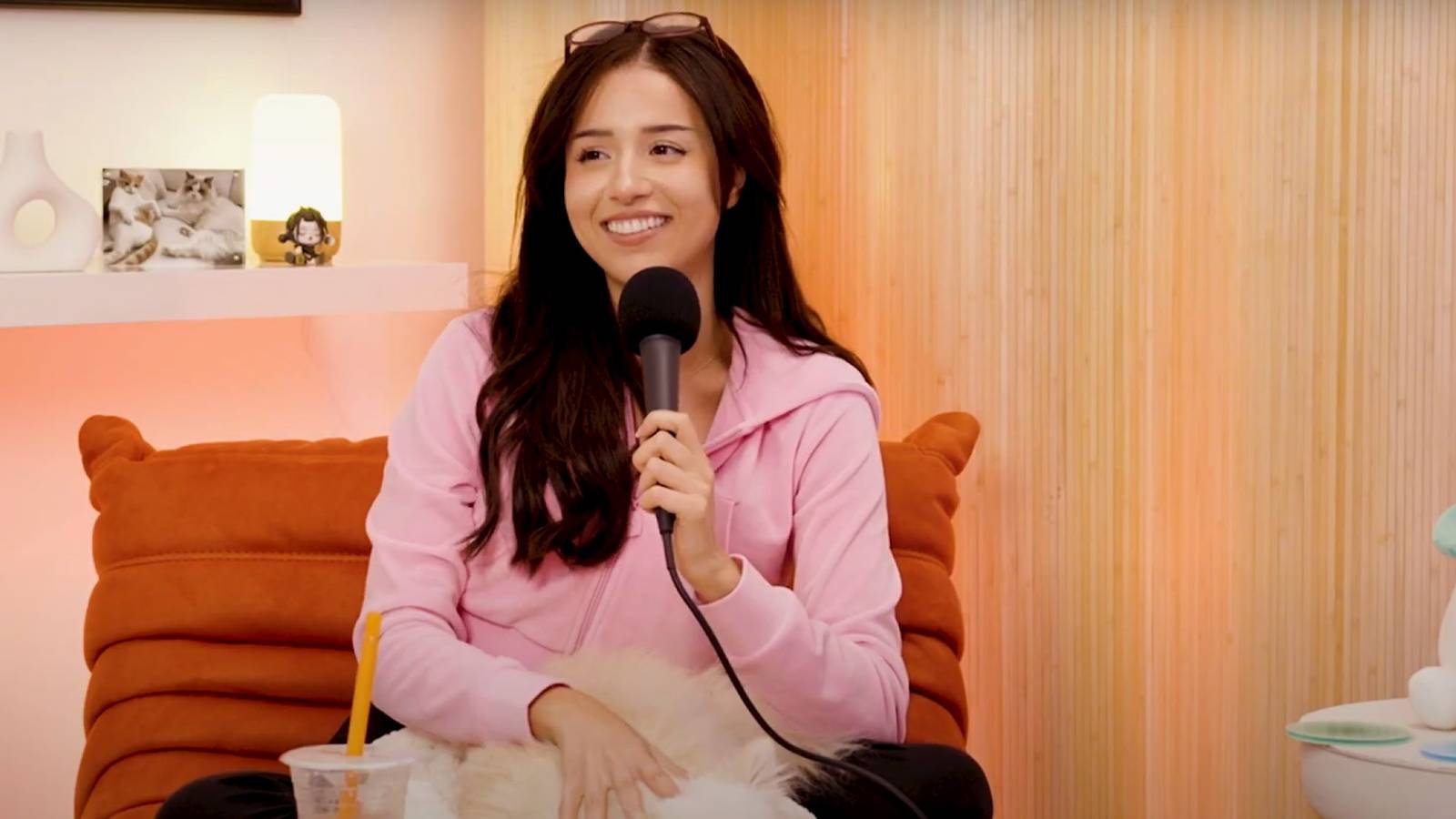 pokimane holding a microphone podcast video