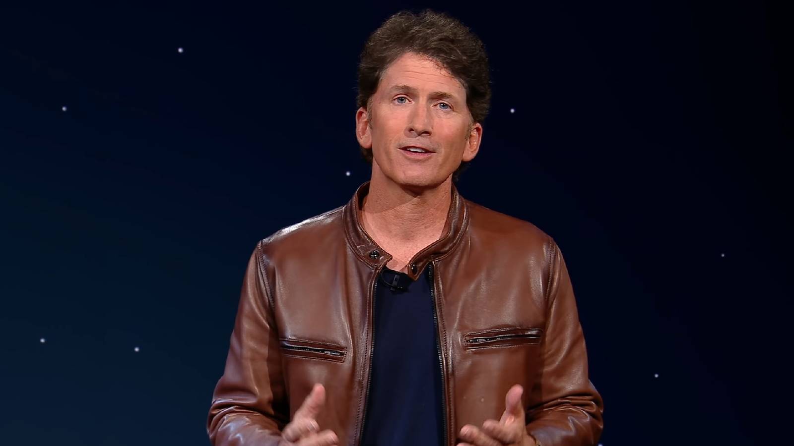 Bethesda director Todd Howard set against a starry sky background.