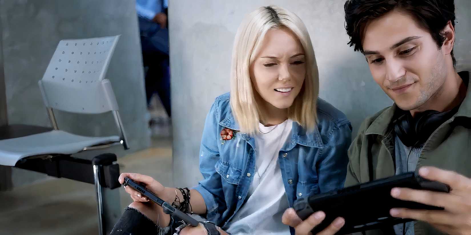Two people playing looking at a Nintendo Switch in reveal trailer