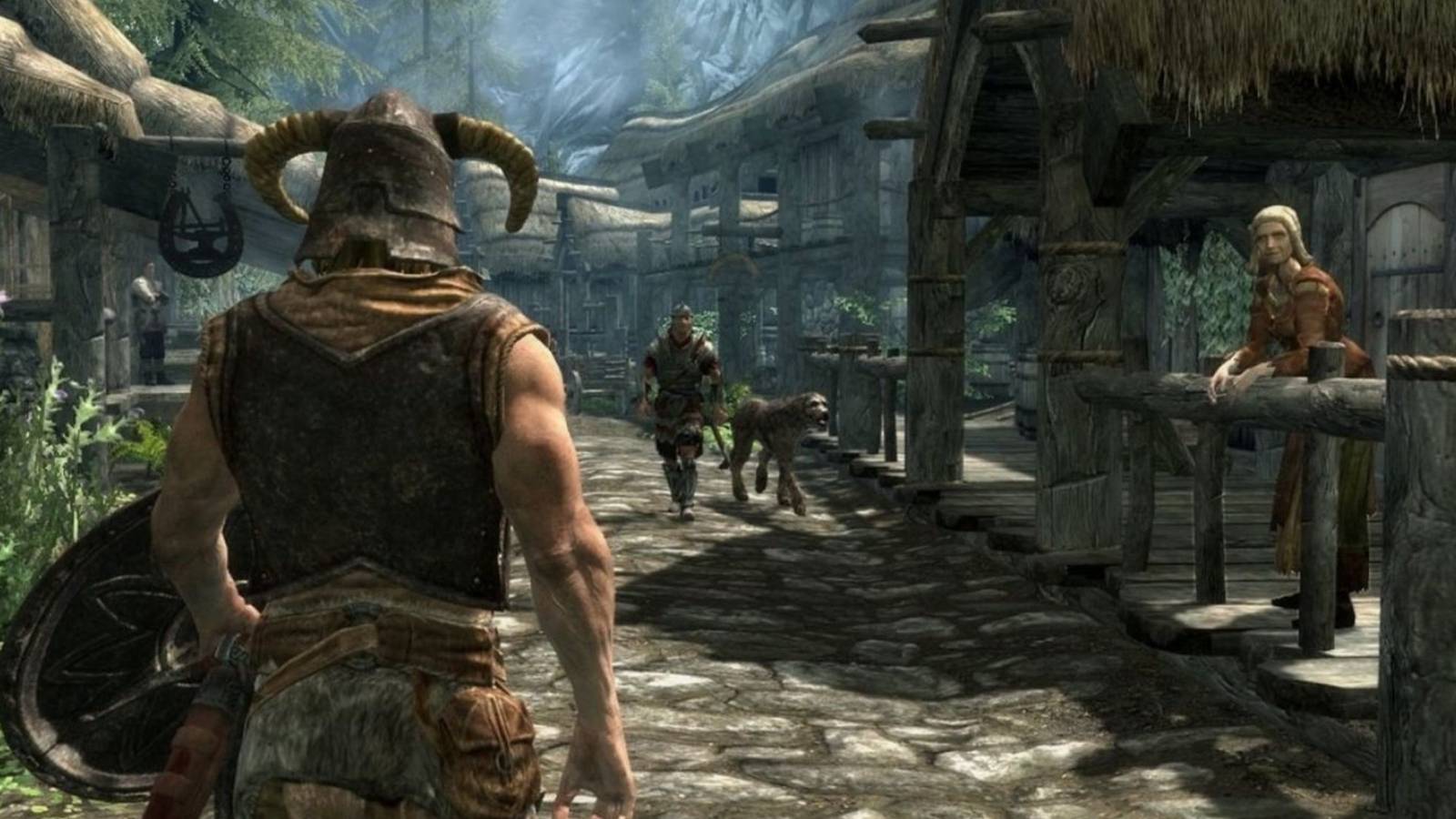 dragonborn in skyrim walking down a path in a village