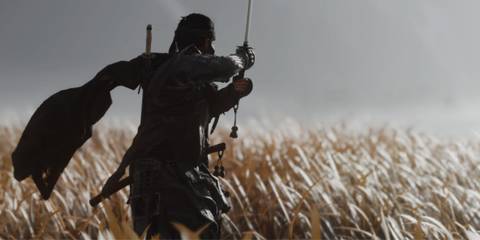 Jin Sakai holding a sword in a field 