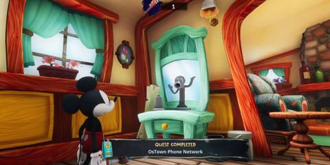 Mickey talking to a phone in Epic Mickey: Rebrushed