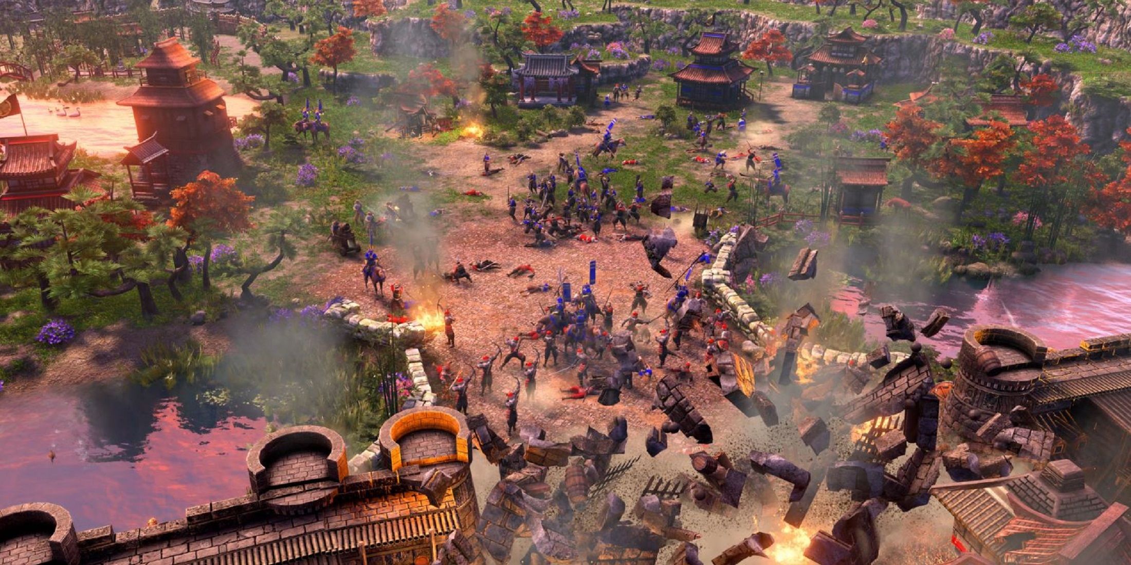 Battle scene with armies clashing and structures collapsing in an Asian-inspired village from Age of Empires 3