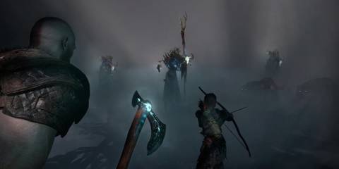 Kratos and Atreus fighting enemies in fog in God of War 2018