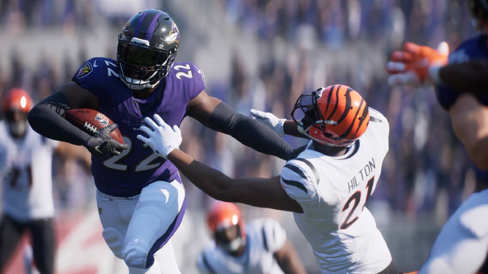Baltimore Raven's player running with the ball while a Bengals defender trying to stop him