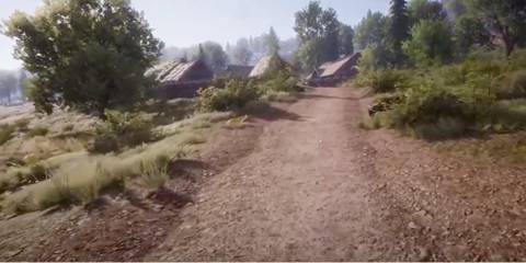 A dirt road leading to houses