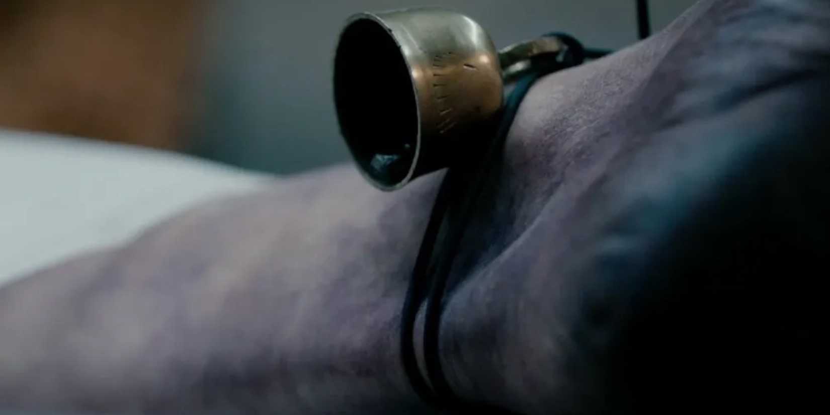 a bell hangs on a cadaver foot