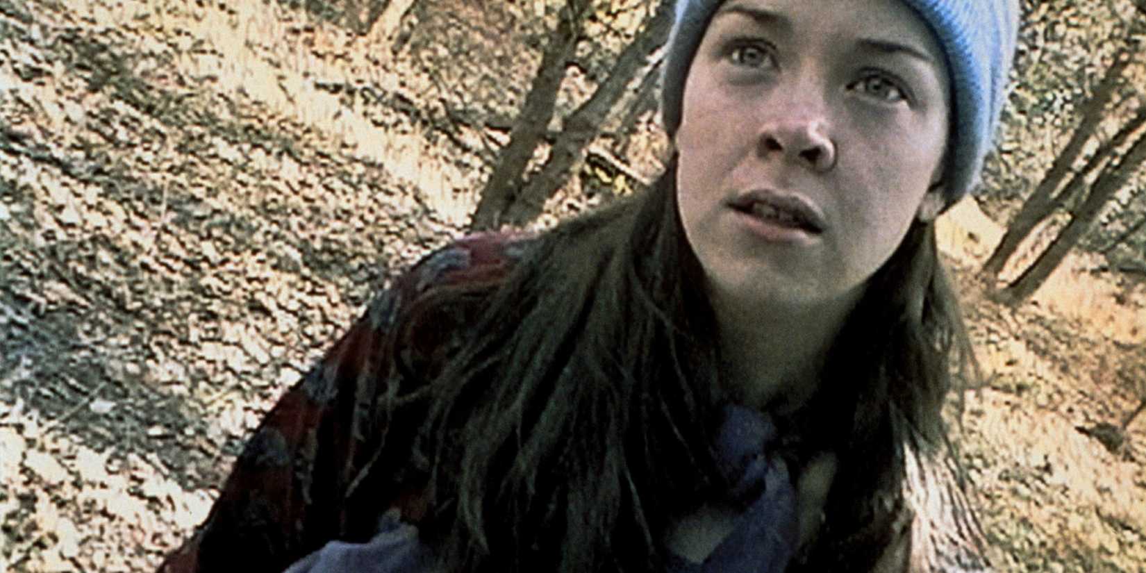 grainy found film footage of a young woman in the woods 