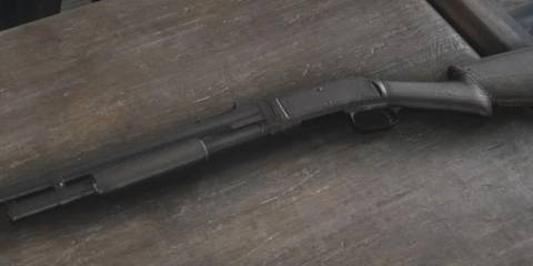 Pump action shot gun on a table