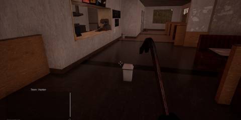 Prop Hunt crowbar wielding player looks suspiciously at bin in middle of corridor