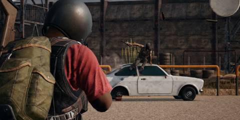 PUBG Character aiming at an enemy near a car.