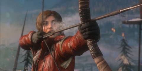 Lara Croft aiming a bow and arrow surrounded by a snow-covered forest in Rise Of The Tomb Raider