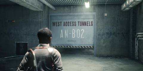 Sebastian walking toward a steel door that says West Access Tunnels