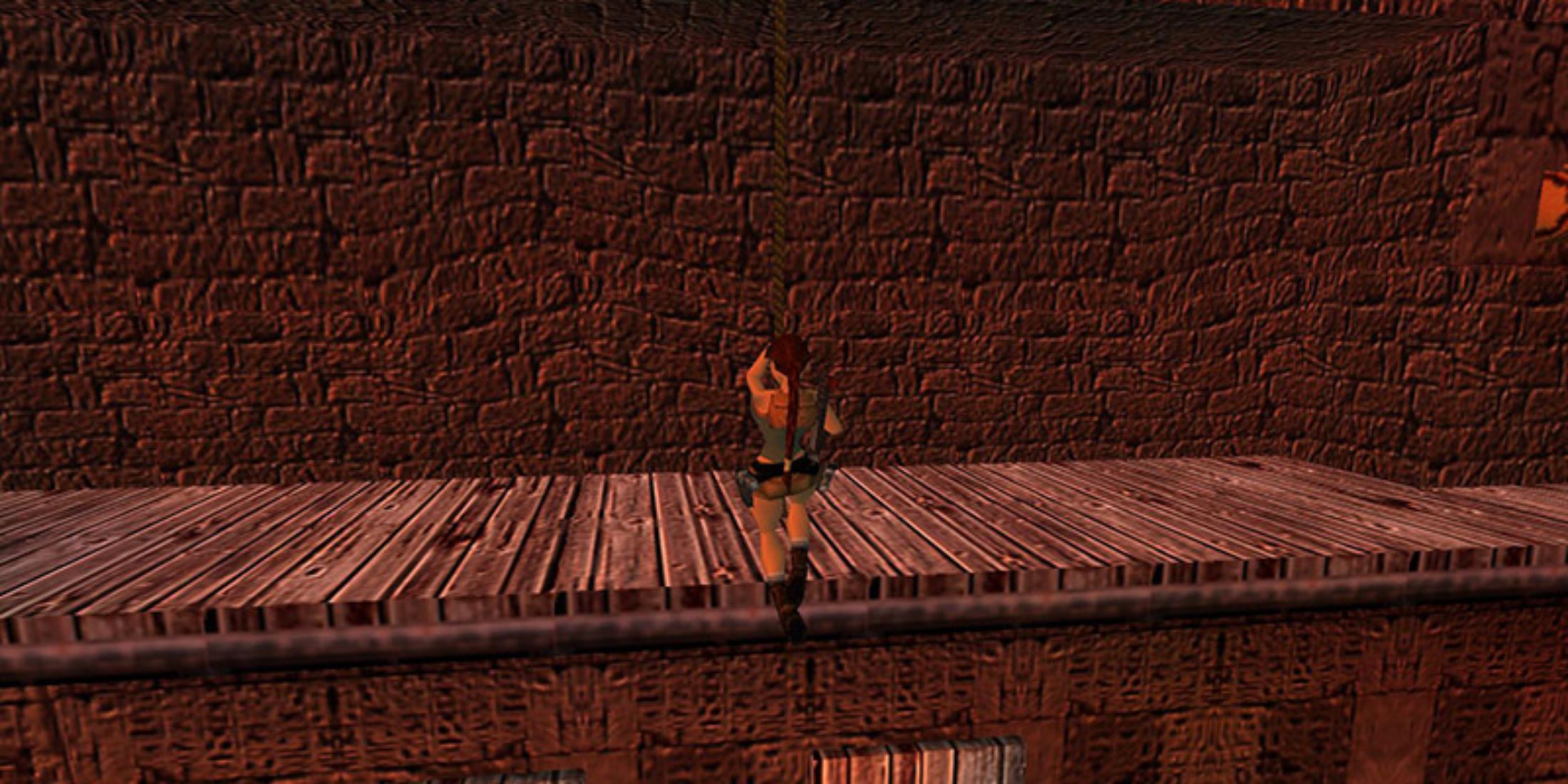 Lara Croft using a rope swing