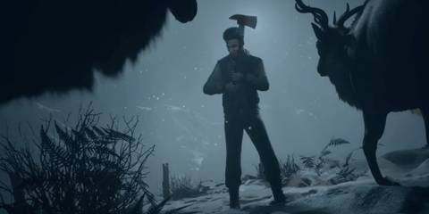 Matt wielding an axe in a snowstorm against a group of deer in Until Dawn