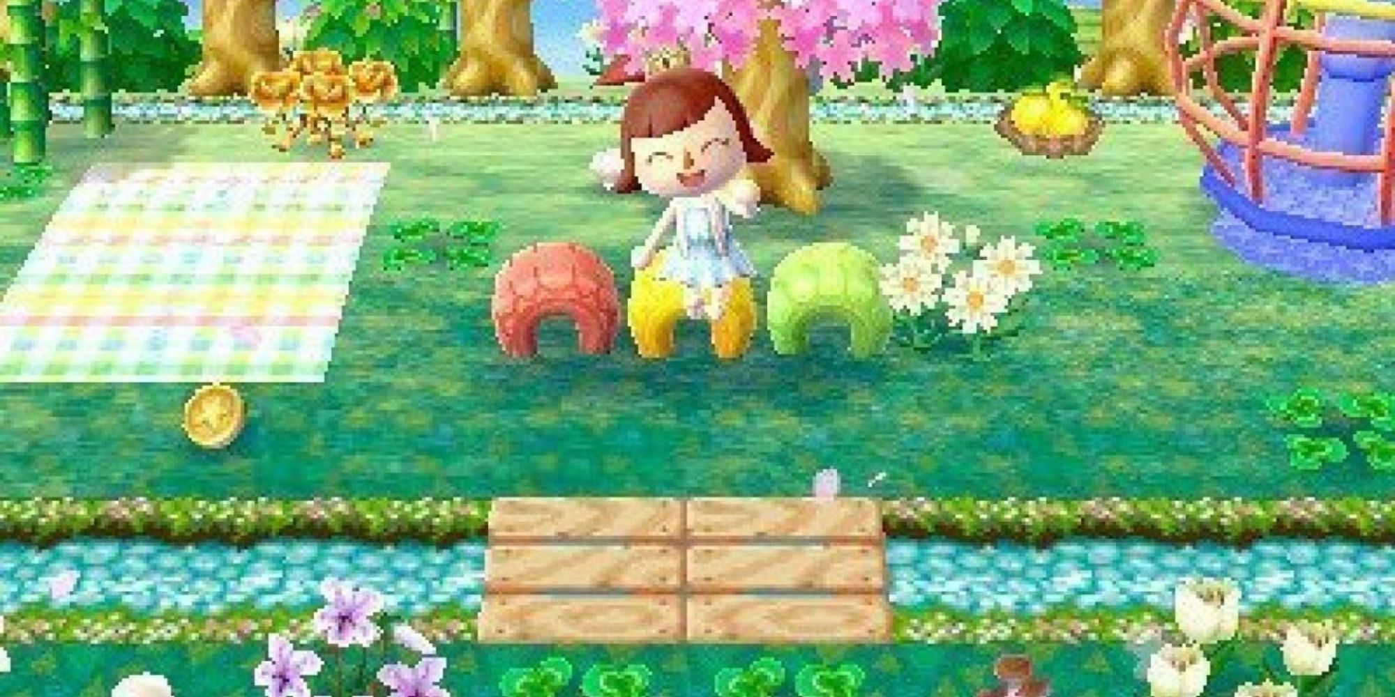 A player sitting on a colorful tyre waving in Animal Crossing: New Leaf