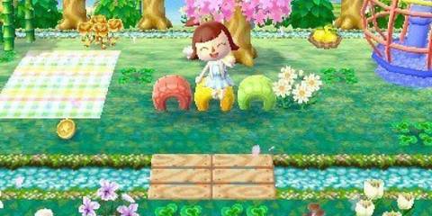 A player sitting on a colorful tyre waving in Animal Crossing: New Leaf