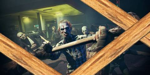 Zombies from No More Room In Hell 2 blocked by a wooden barricade