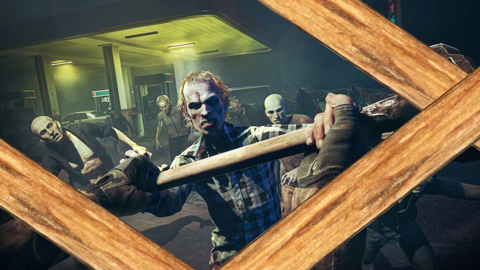 Zombies from No More Room In Hell 2 blocked by a wooden barricade