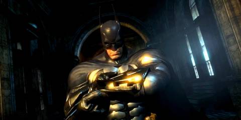 Batman looking at his wrist pad in Batman: Arkham City - Armored Edition