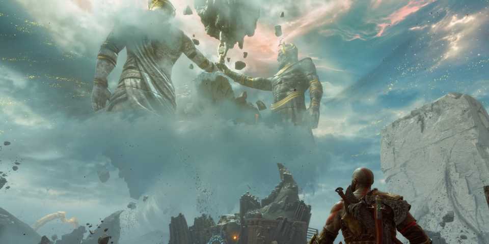 Kratos gazing at colossal statues in a mystical, cloudy landscape in God of War Ragnarok