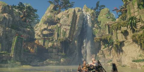 Kratos and Atreus in a serene, lush valley with a waterfall in the background.