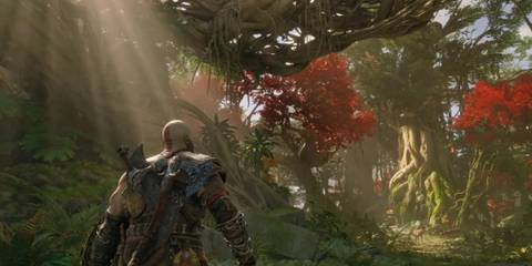 Kratos in a sunlit forest surrounded by vibrant, glowing trees.