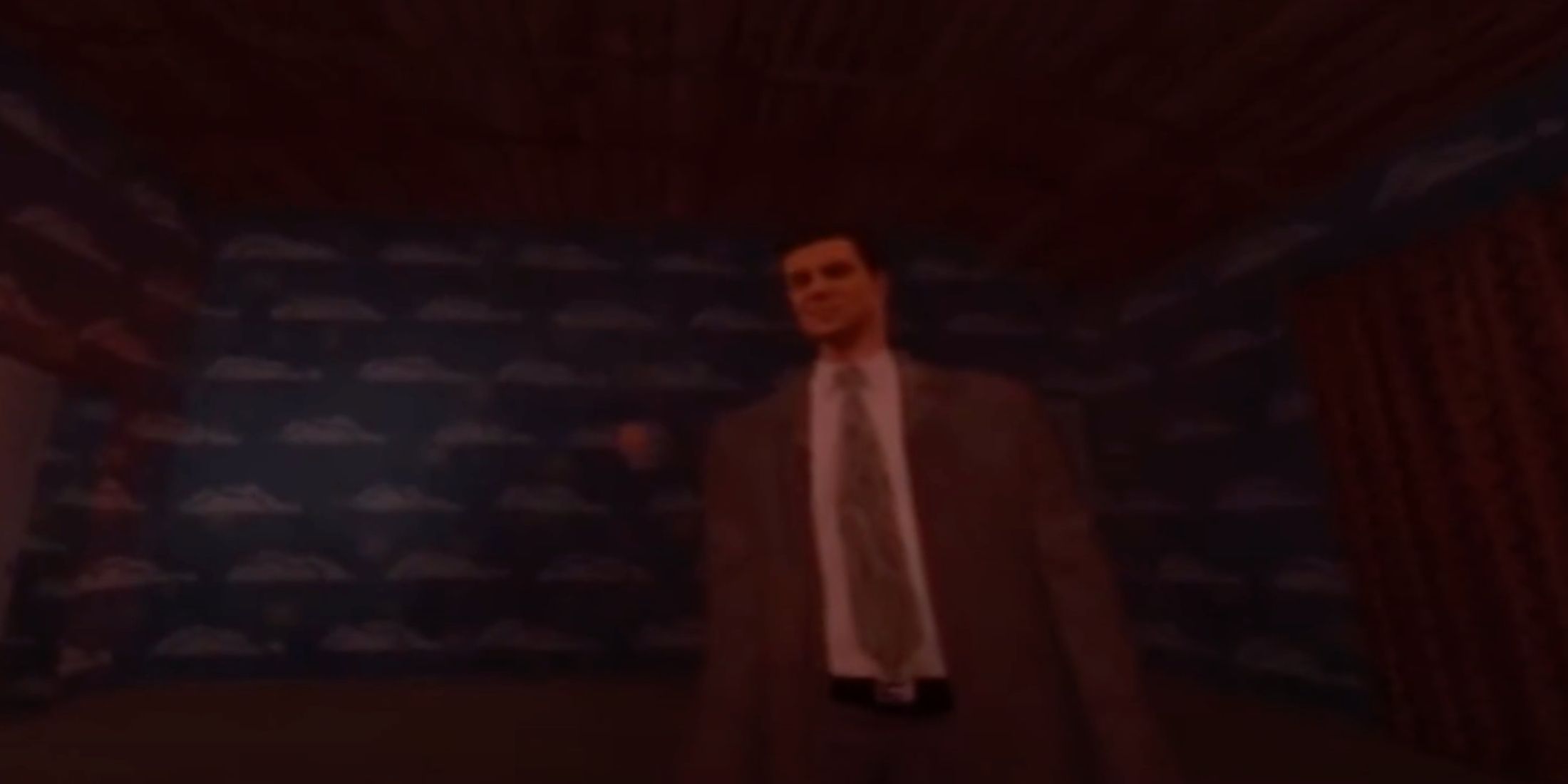 A close-up of Max Payne bathed in a red glow