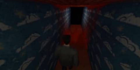 Max Payne walking through a corridor with a blood splatter on the floor