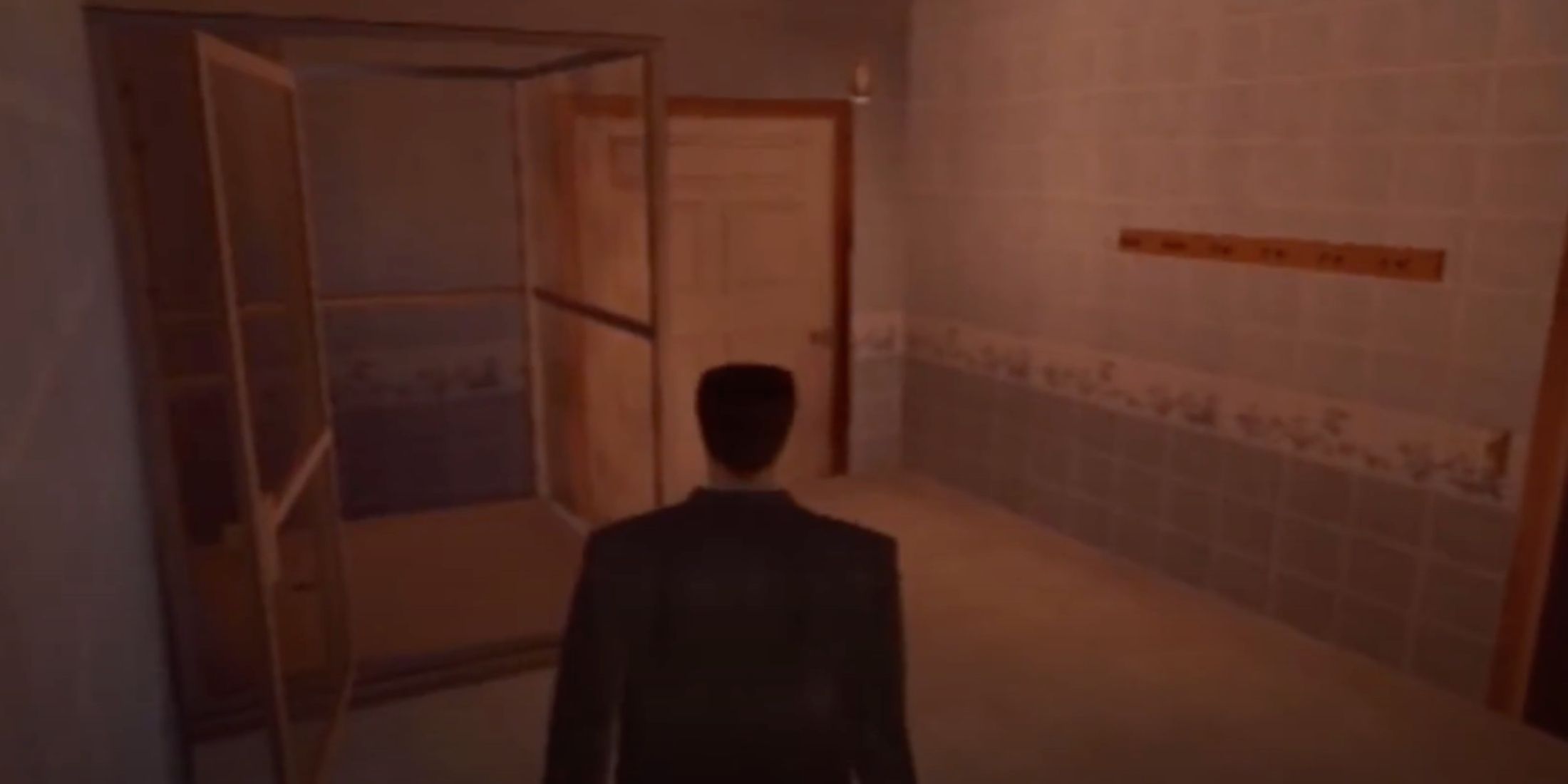 Max Payne walking through a bathroom with an ominous red glow