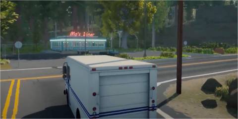 a postal van at an intersection, a diner in the distance