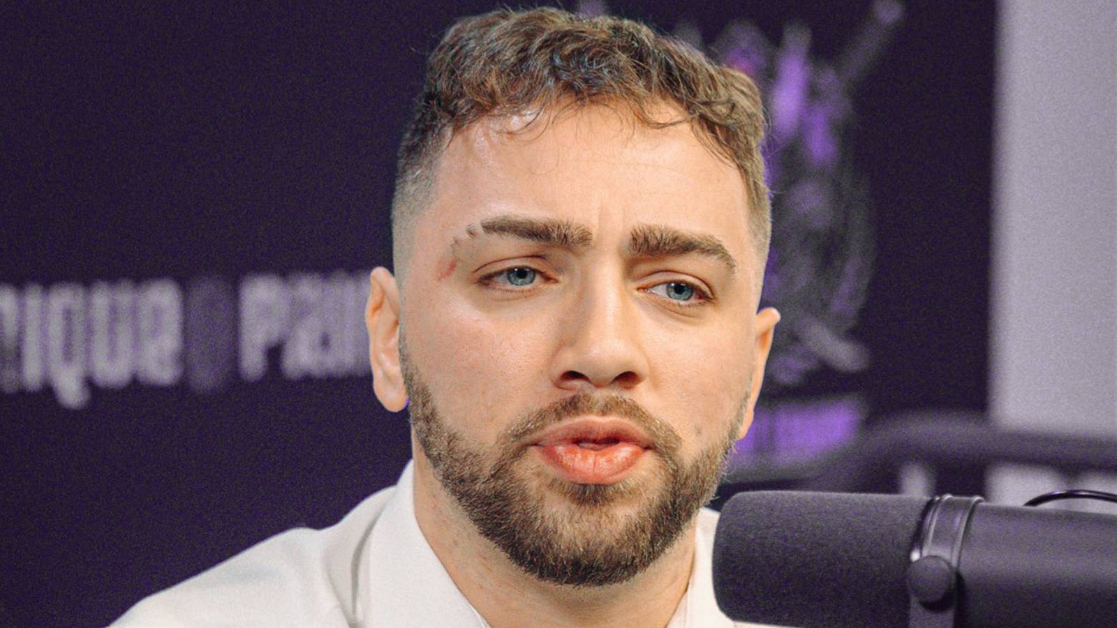 Mizkif in front of microphone purple background 2x1 composite