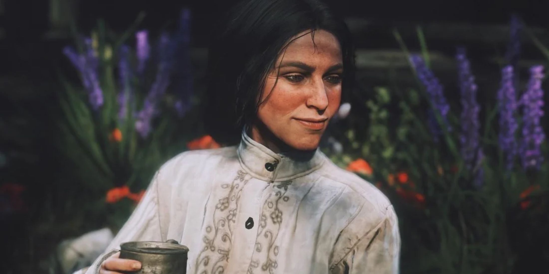 Charlotte Balfour sitting and drinking a beverage among lavender plants