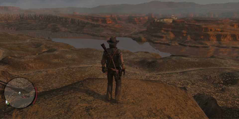 John Marston standing on a cliff side overlooking a valley in Red Dead Redemption