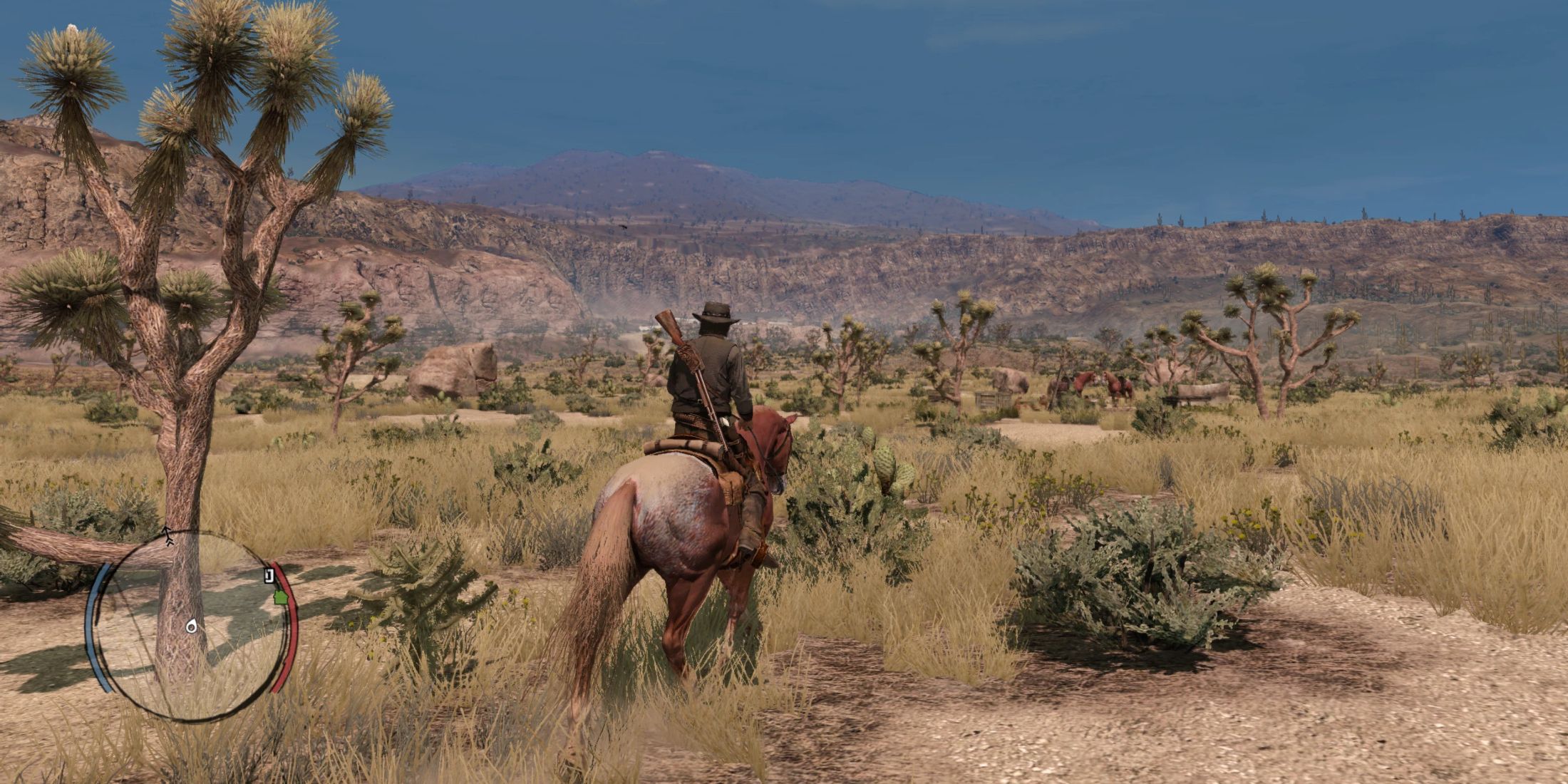 John Marston riding his horse while overlooking a rocky landscape in Red Dead Redemption