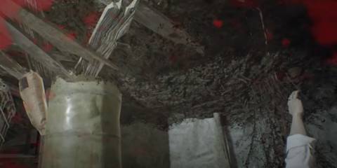 Ethan Winters' arm sticking out in the corner of Marguerite Baker's lair