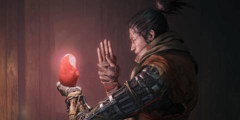 Sekiro holding a Jizo Statue in Sekiro: Shadows Die Twice 