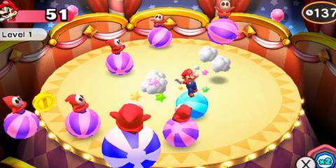 mario on a ball next to shy guys