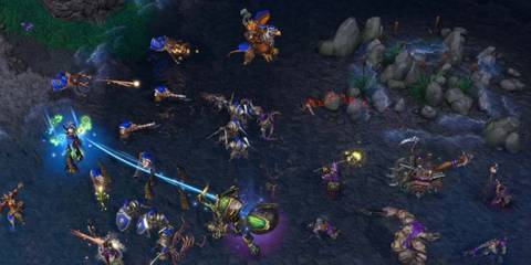 Alliance forces battling undead creatures at night in Warcraft III: Reforged