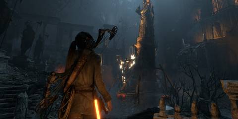 Lara Croft walking through a tomb in Rise Of The Tomb Raider