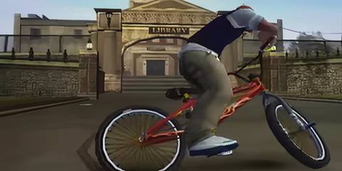 jimmy riding his bike in front of the library