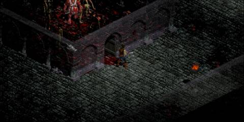 Character approaching a blood-stained dungeon entrance surrounded by gothic architecture in Diablo