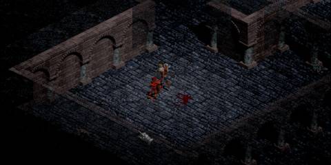 Character battling a demon in a stone dungeon with bloodstains in Diablo