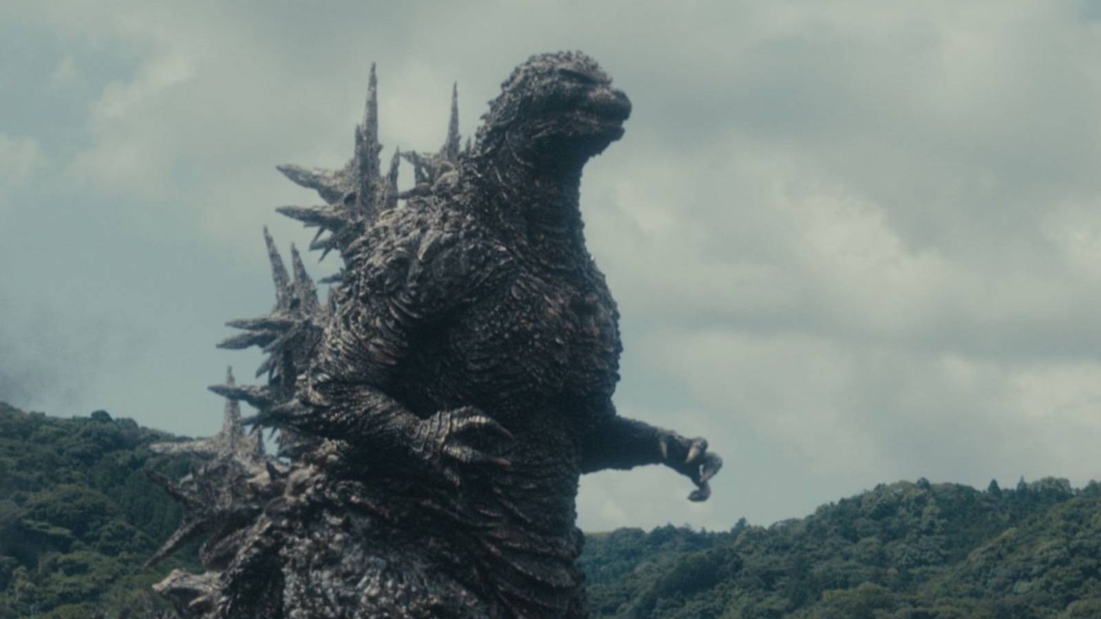 Godzilla walking through Japan and destroying everything in his path.
