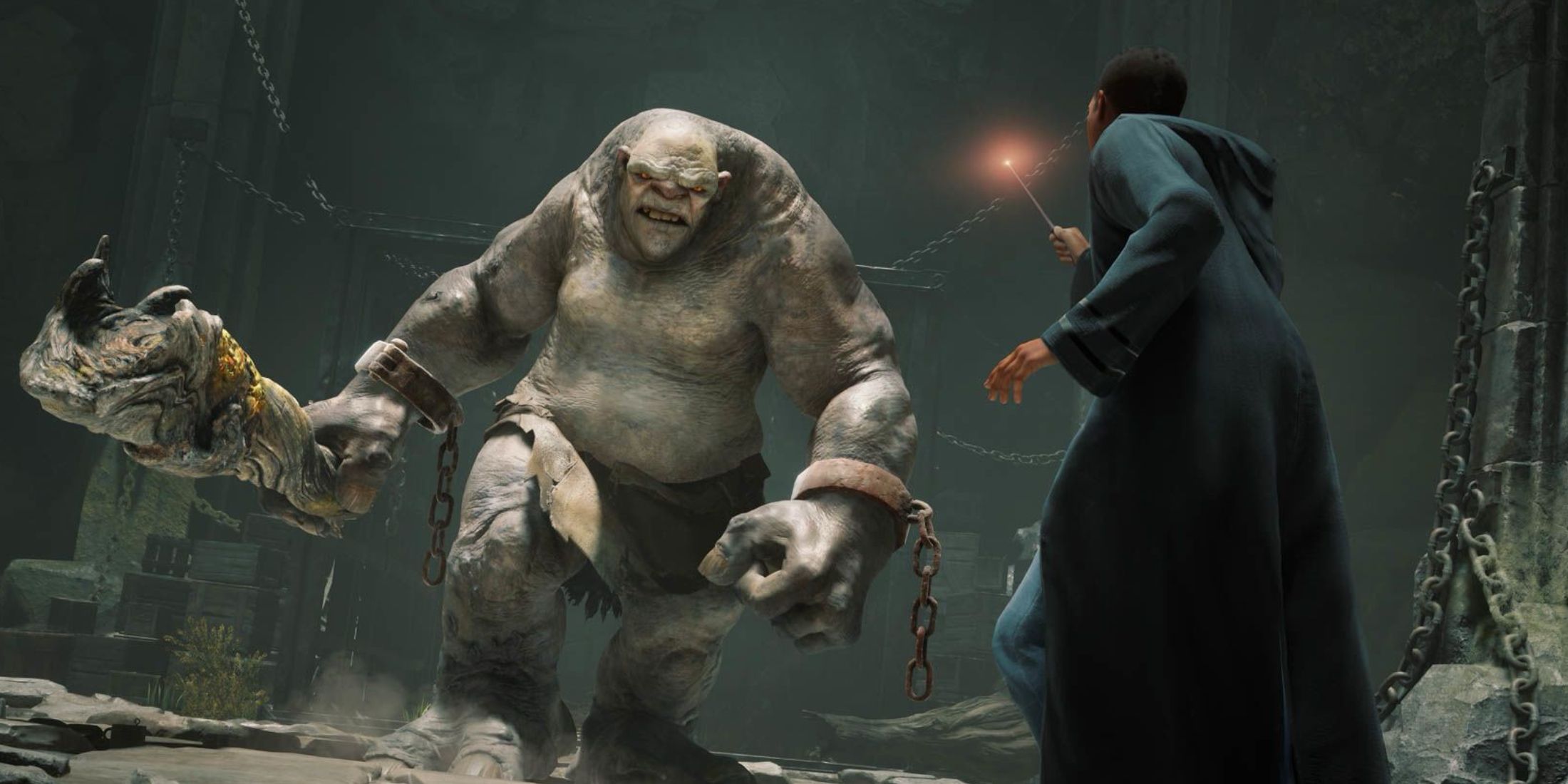 A wizard fighting a troll in Hogwarts Legacy