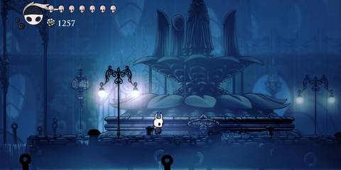 Hollow Knight player standing next to a fountain