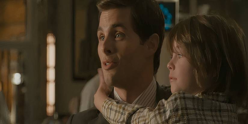 James Marsden holding a child as Richard White in Superman Returns