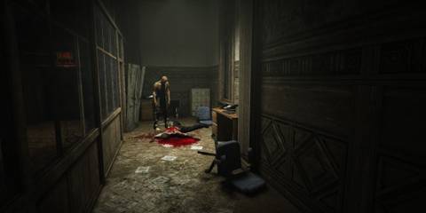 a bloody corpse at the end of a corridor in Outlast